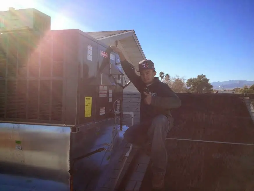 HVAC technician performing Air Duct Repair on a rooftop unit in Franklin
